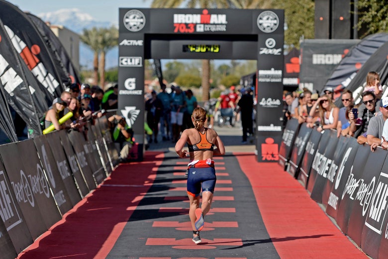 A woman runs toward the finish line at the Ironman 70.3 Indian Wells La Quinta on Dec. 9 in California.